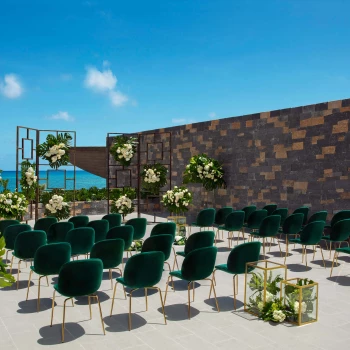 Wedding terrace with green chairs and altar at Dreams Natura Resort and Spa