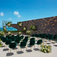 Wedding terrace with green chairs and altar at Dreams Natura Resort and Spa