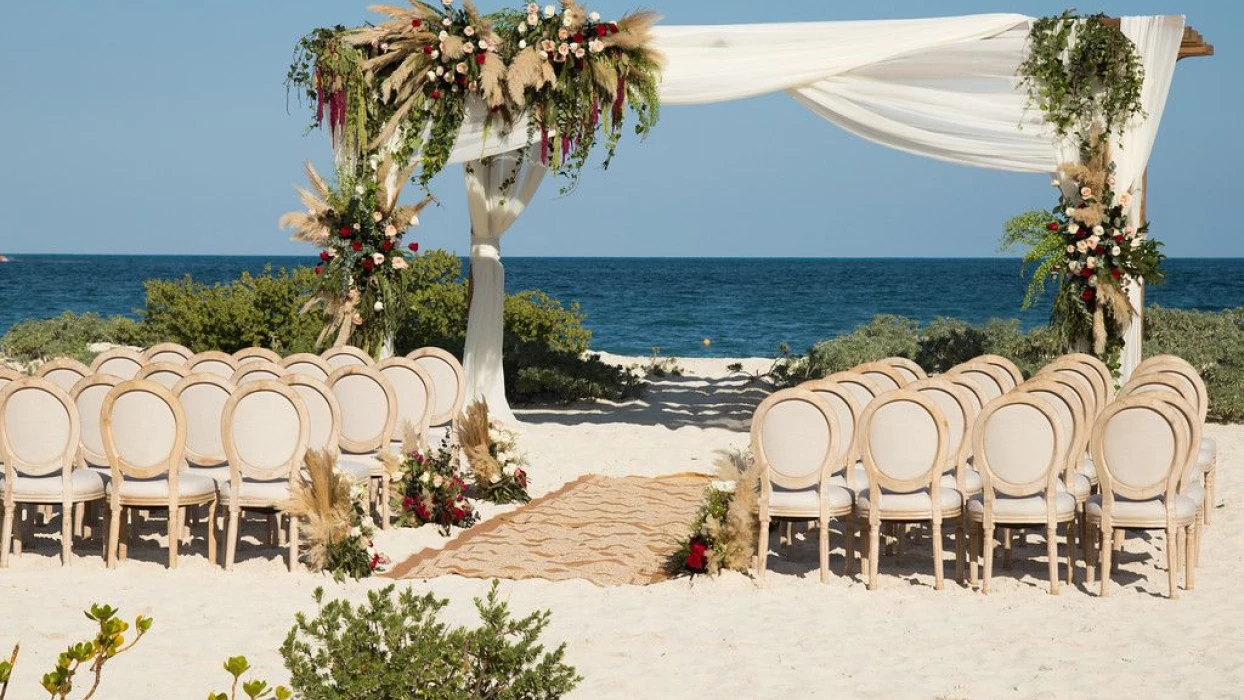 Dreams Playa Mujeres beach wedding venue with flowers and canopy