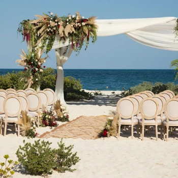 Dreams Playa Mujeres beach wedding venue with flowers and canopy