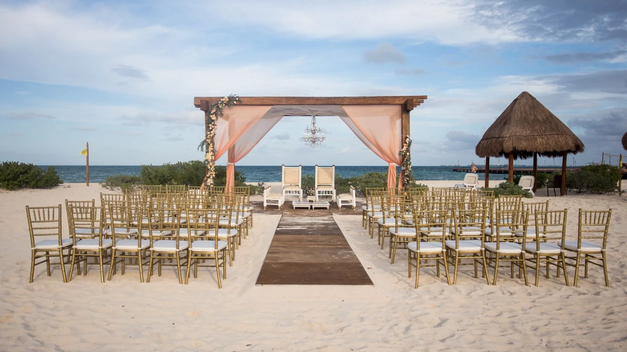 Beach wedding venue with altar at Dreams Playa Mujeres Golf and Spa