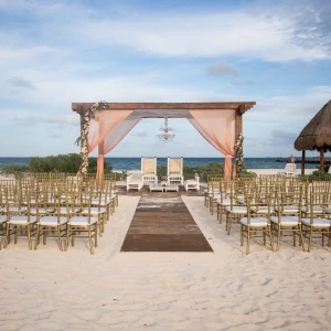 Beach wedding venue with altar at Dreams Playa Mujeres Golf and Spa