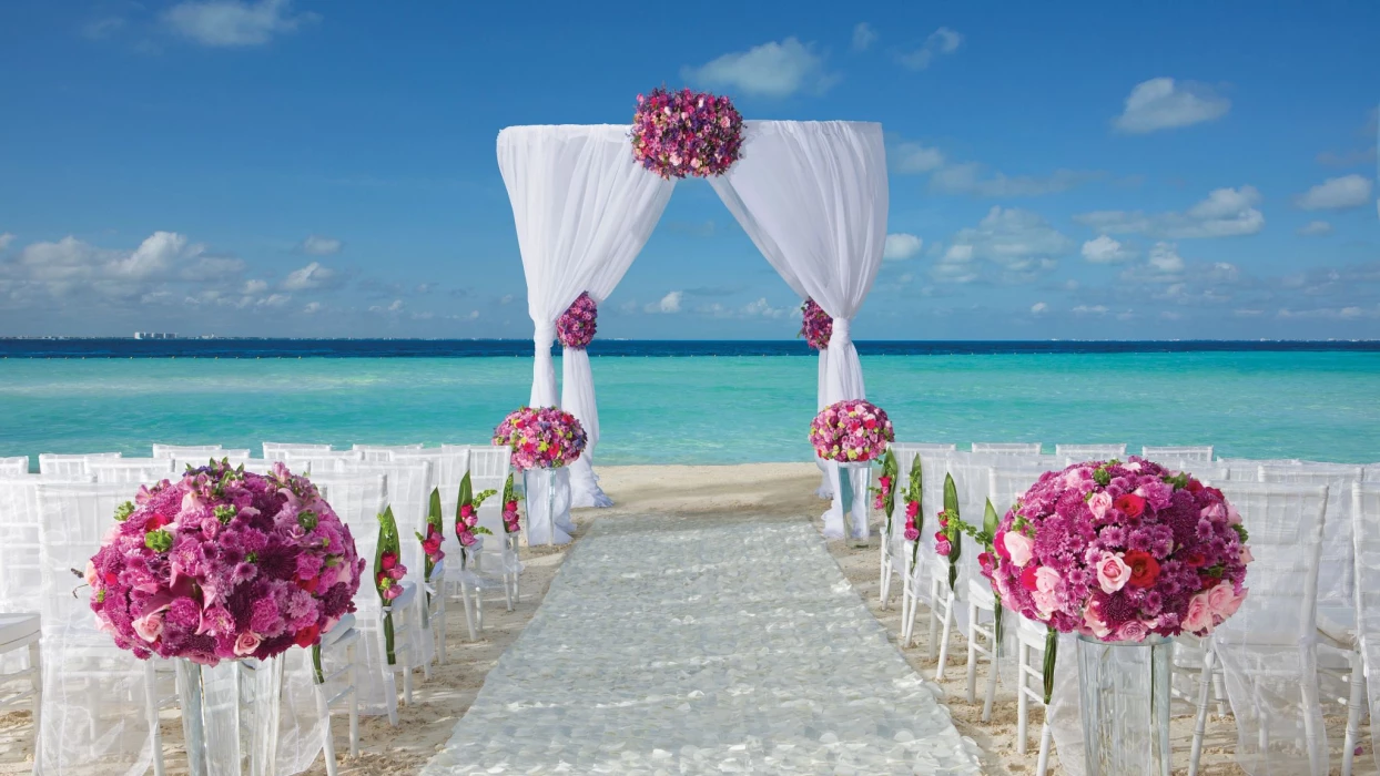 Dreams Sands Cancun beach wedding venue with chair and altar