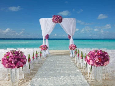Dreams Sands Cancun beach wedding venue with chair and altar