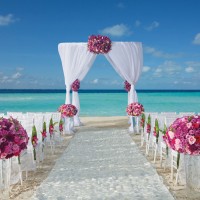 Dreams Sands Cancun beach wedding venue with chair and altar