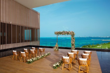 Terrace wedding venue overlooking ocean and golf atDreams Vista Cancun Golf and Spa