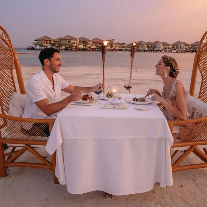 Couple having a romantic dinner at El Dorado Maroma beach