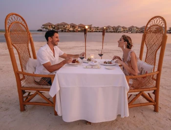 Couple having a romantic dinner at El Dorado Maroma beach