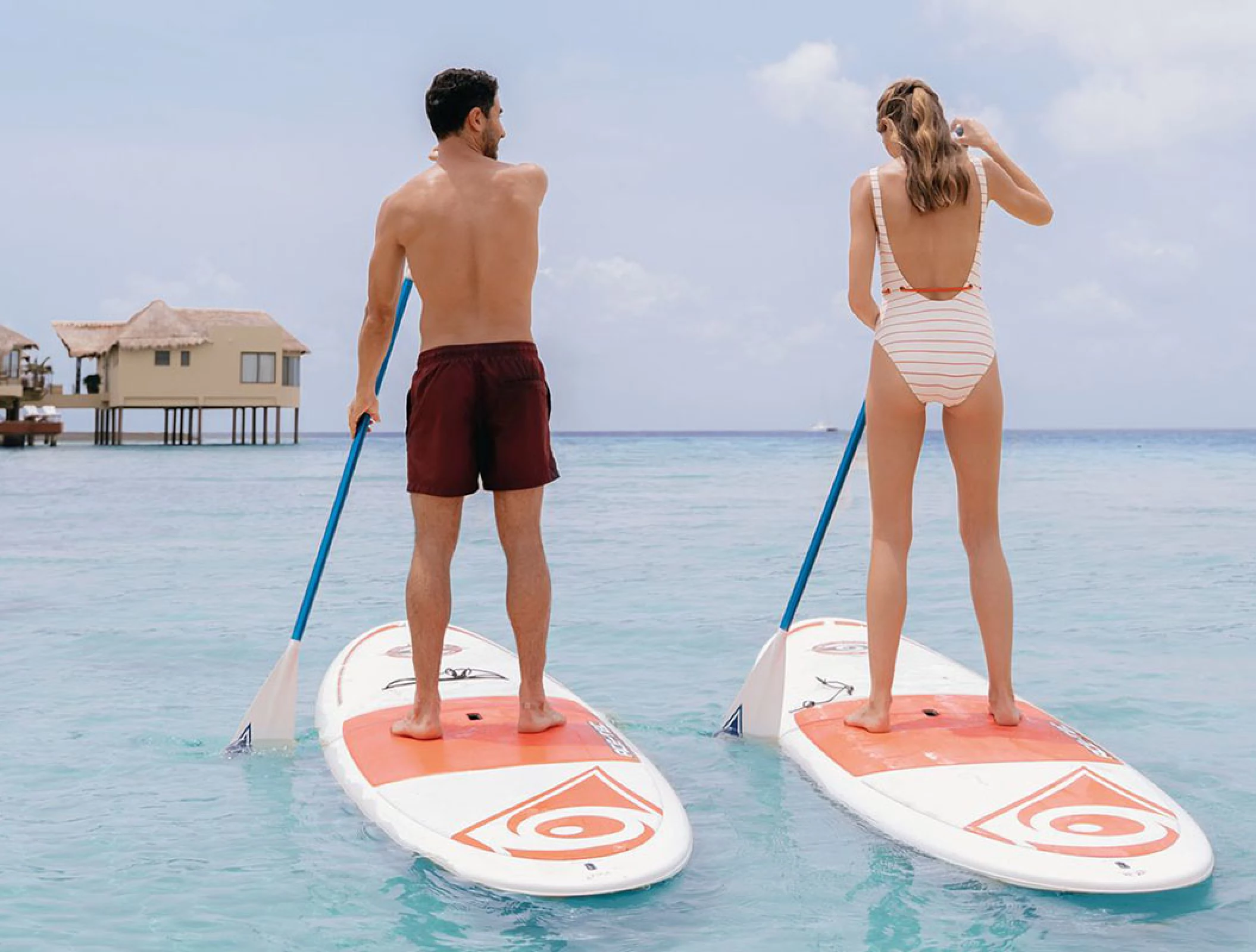 Couple enjoying paddlesurf at El Dorado Maroma