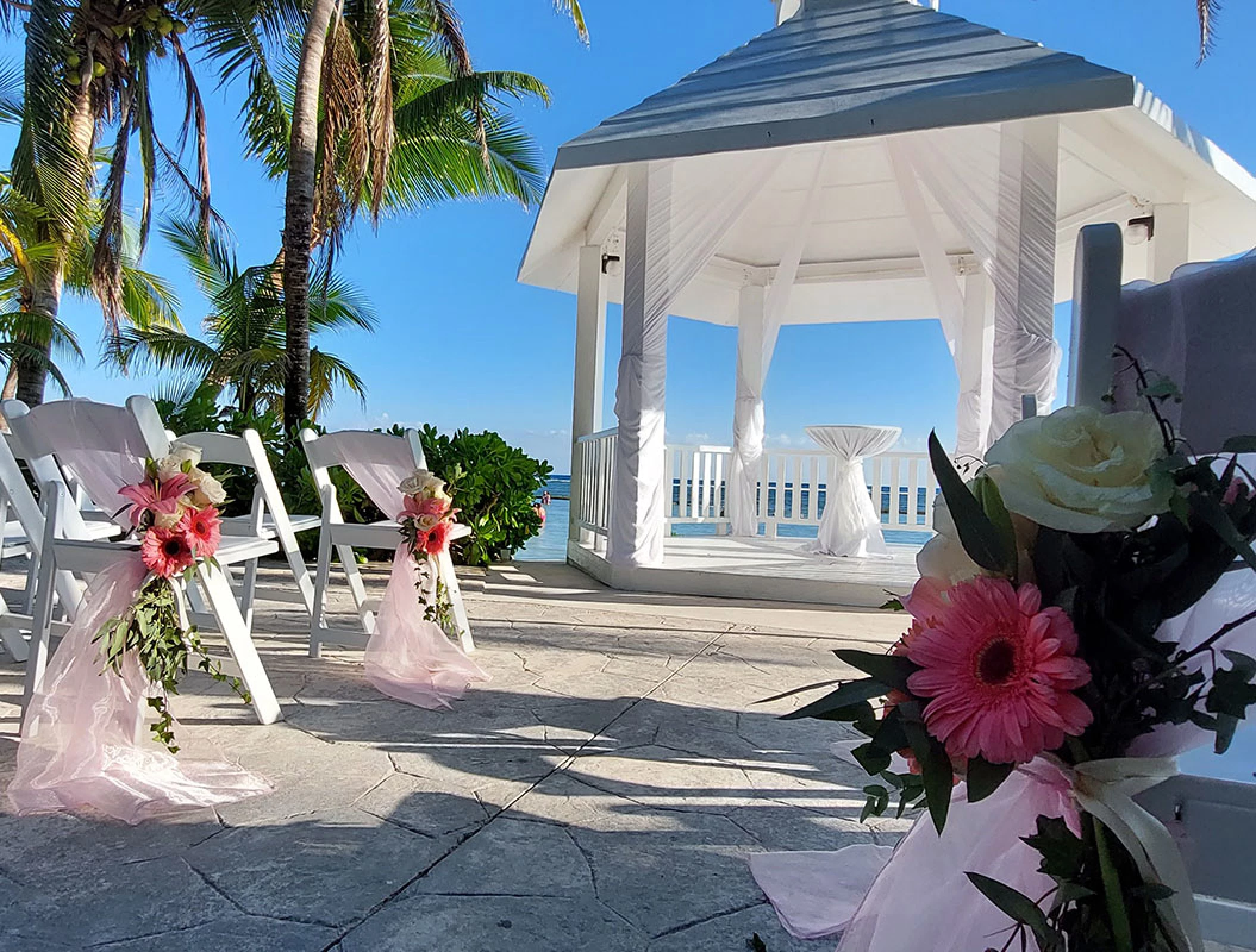 Chair decoration details set on white gazebo at El dorado Seaside suites