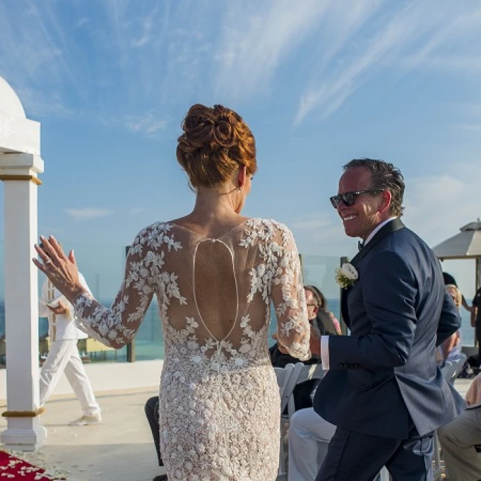 Couple marrying at Palafitos Sky deck venue at El dorado Maroma