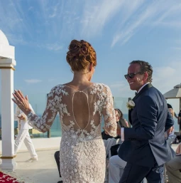 Couple marrying at Palafitos Sky deck venue at El dorado Maroma