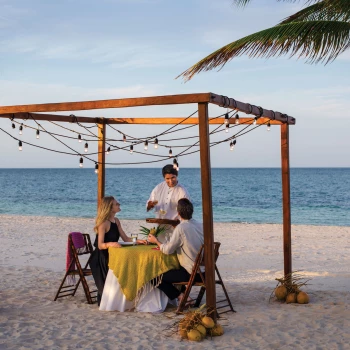 Excellence Playa Mujeres couple having dinner on beach