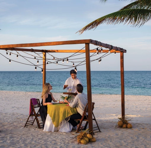 Excellence Playa Mujeres couple having dinner on beach