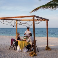Excellence Playa Mujeres couple having dinner on beach