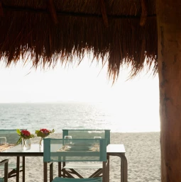 Finest Playa Mujeres table under palapa on beach