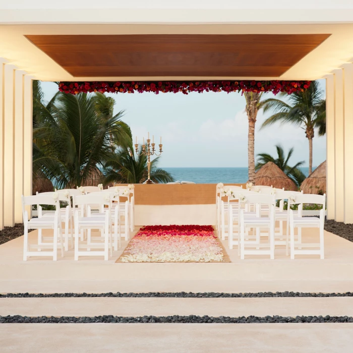 Finest Playa Mujeres gazebo wedding venue facing beach with white chairs