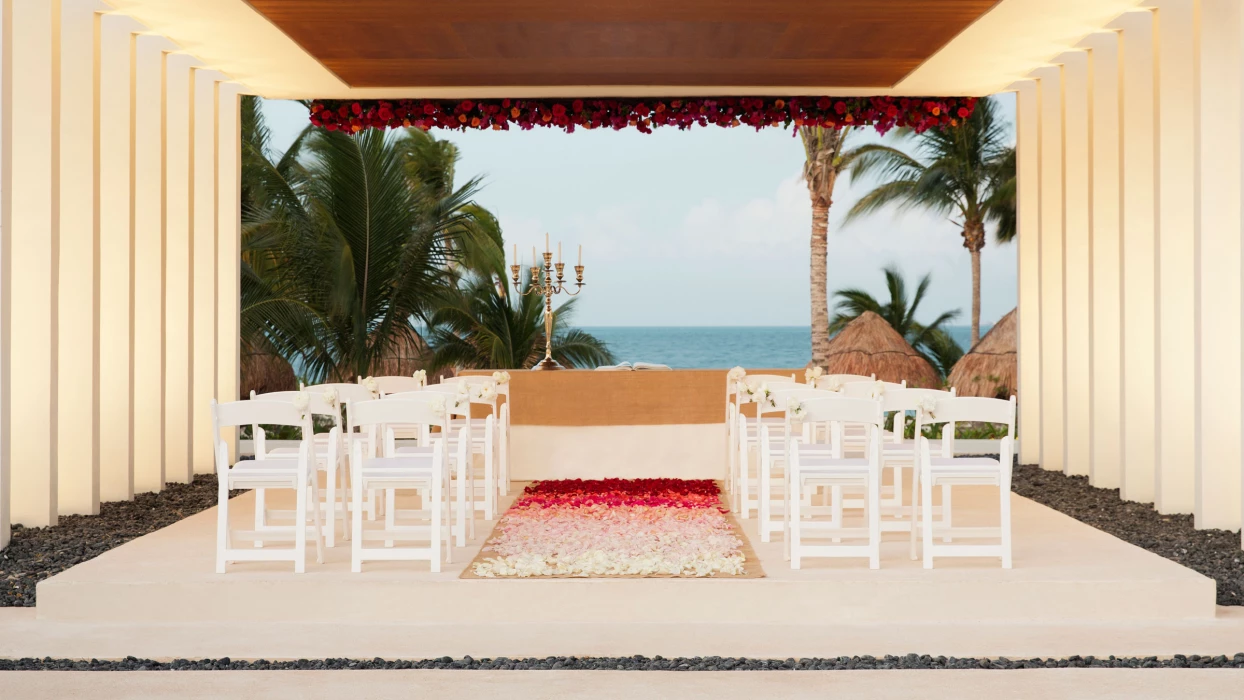 Finest Playa Mujeres gazebo wedding venue facing beach with white chairs