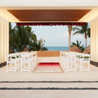 Finest Playa Mujeres gazebo wedding venue facing beach with white chairs