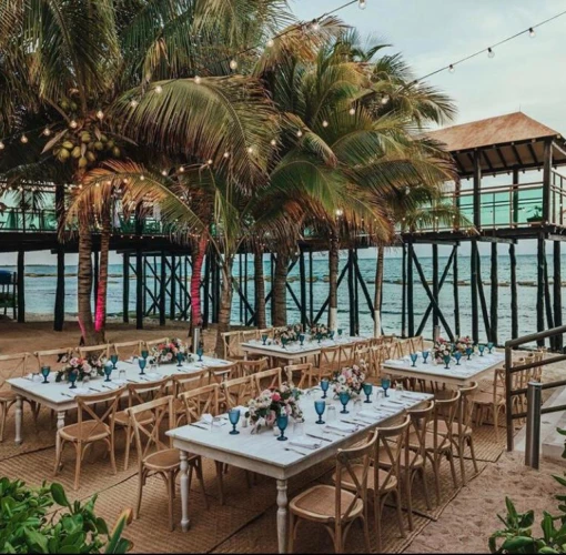 beach reception venue with palm trees at Generations Riviera Maya resort