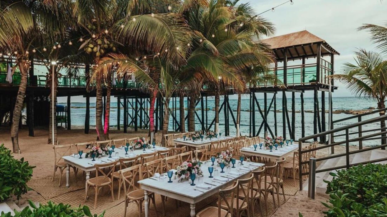 beach reception venue with palm trees at Generations Riviera Maya resort