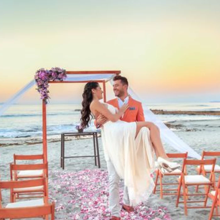 Couple on the beach pergola at grand palladium vallarta