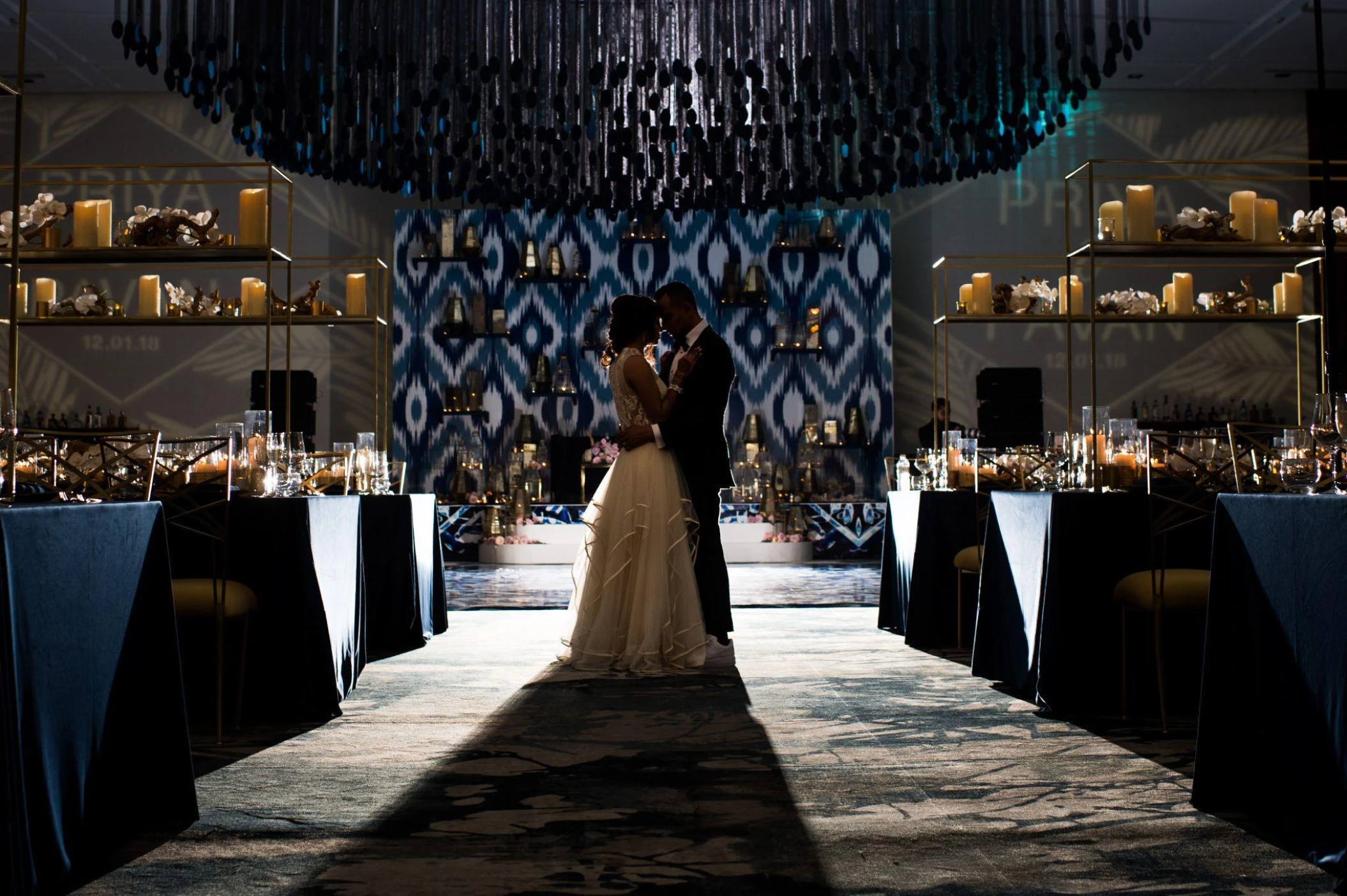 Couple embracing at heir wedding in the Grand Velas Los Cabos Resort ballroom