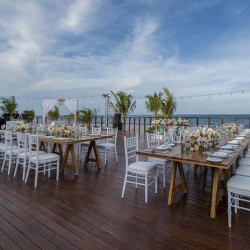 Reception setup at Vora Deck wedding venue at Haven Riviera Cancun Resort.