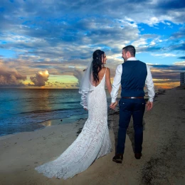 Just married Couple walking away at the beach in Hilton Cancun.