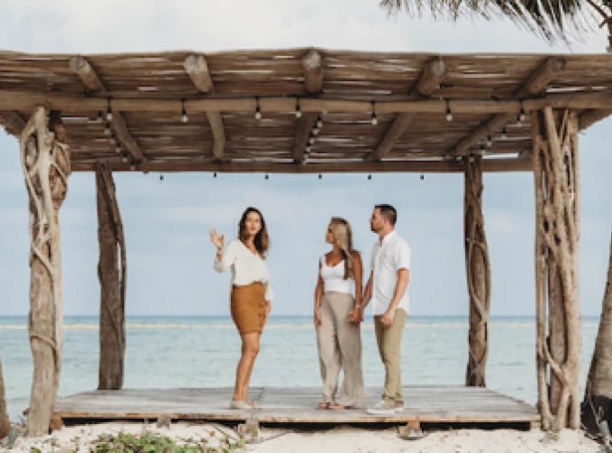 destination wedding travel agent with couple at beach wedding venue