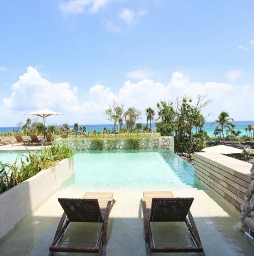 Xcaret Arte oceanfront room swim-up with lounge chairs