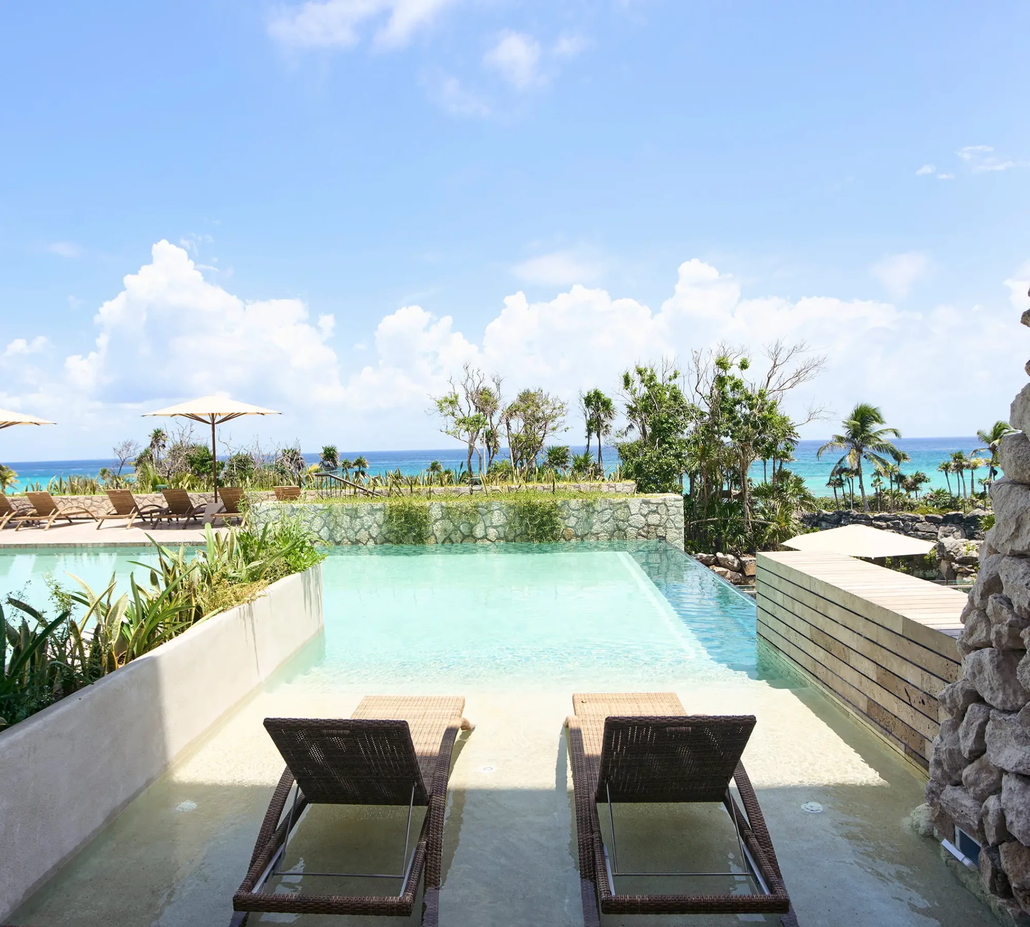 Xcaret Arte oceanfront room swim-up with lounge chairs