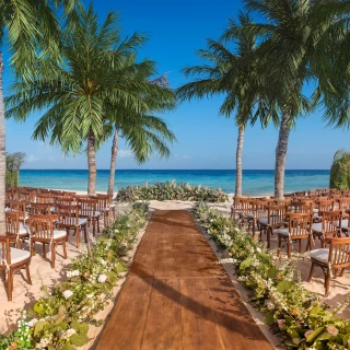 beach wedding venue with chairs at Hotel Xcaret Mexico