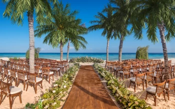 beach wedding venue with chairs at Hotel Xcaret Mexico