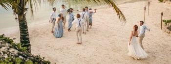 Hotel Xcaret wedding beach party with guests and couples dancing