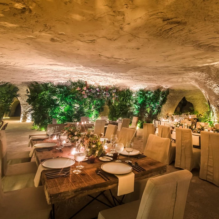 wedding venue reception in caves with tables and chairs at Hotel Xcaret Mexico