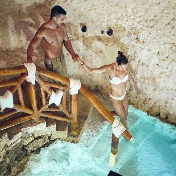 Hotel Xcaret spa with couple walking into cenote