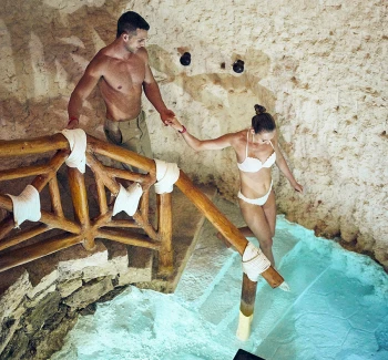 Hotel Xcaret spa with couple walking into cenote