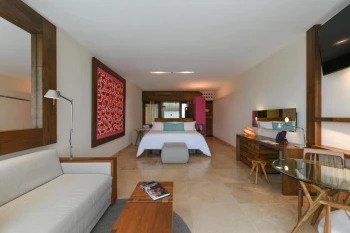 Hotel Xcaret bedroom suite with bed and seating area