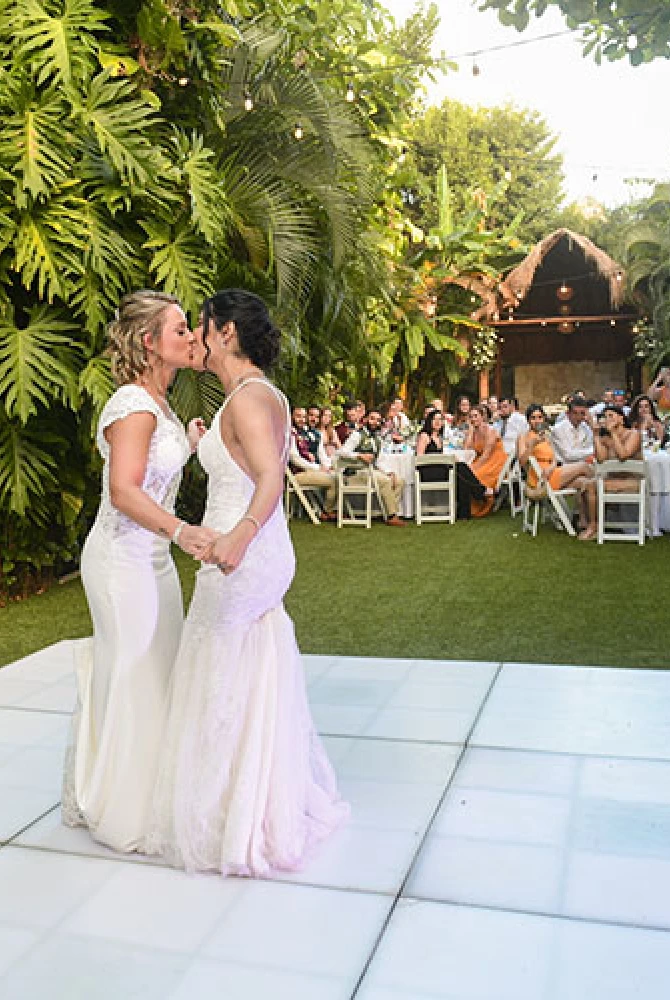 couple kisses during their fisrt dance while the group watch