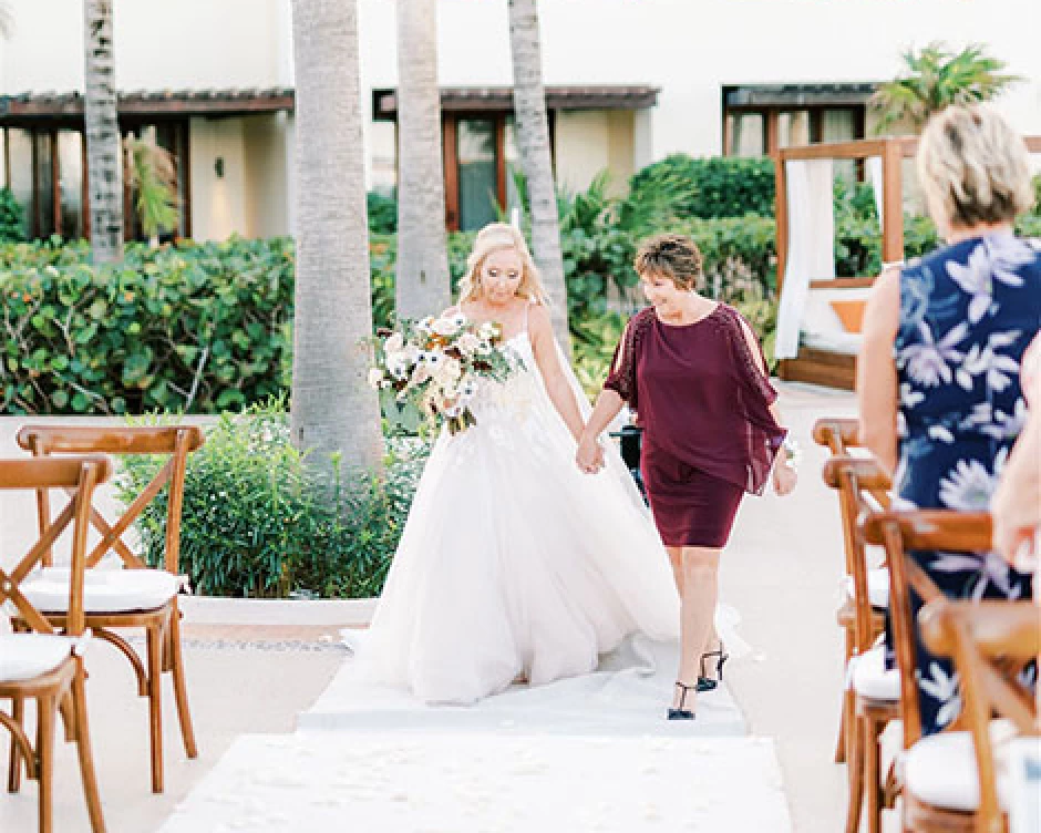 Bride with her mom walking down the isle