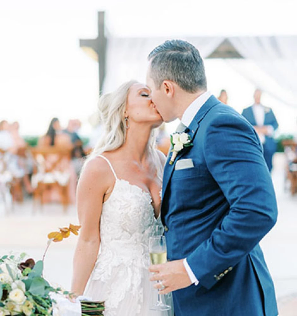 Bride kissing groom in front of the isle