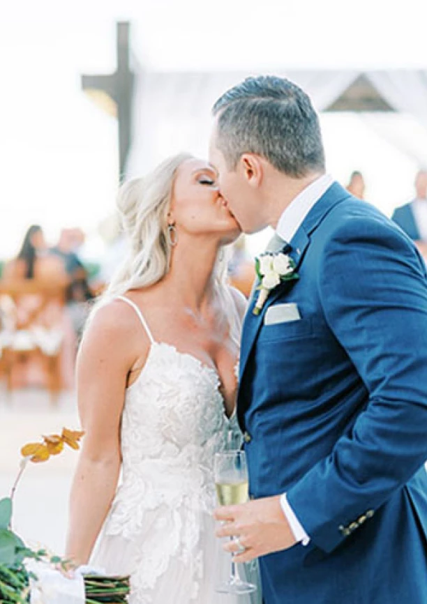 Bride kissing groom in front of the isle