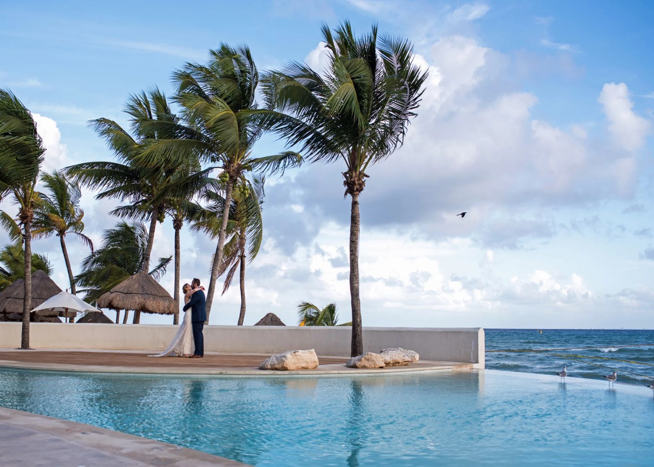 Couple next to the pool at Mahekal Beach Resort