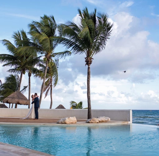 Couple next to the pool at Mahekal Beach Resort