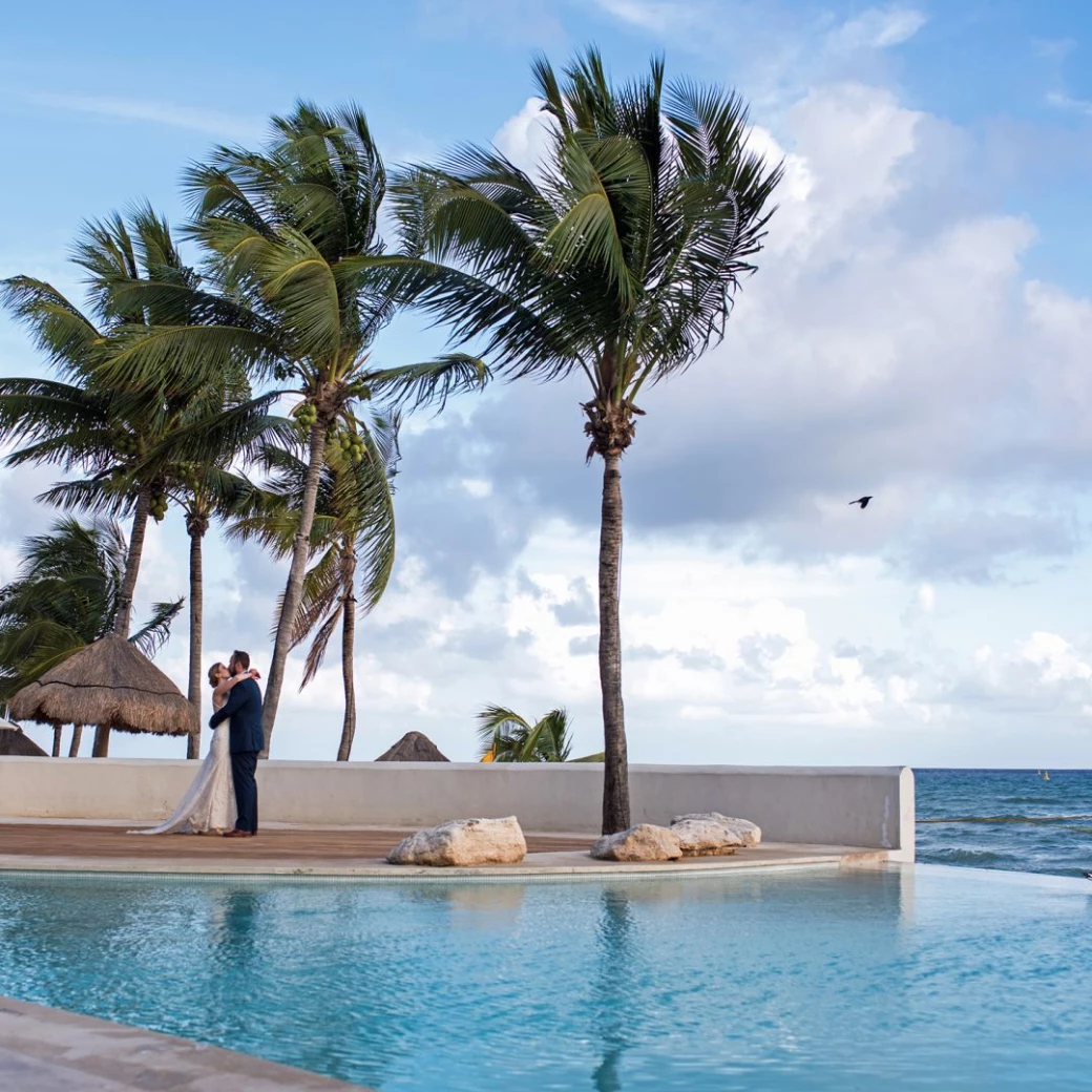 Couple next to the pool at Mahekal Beach Resort