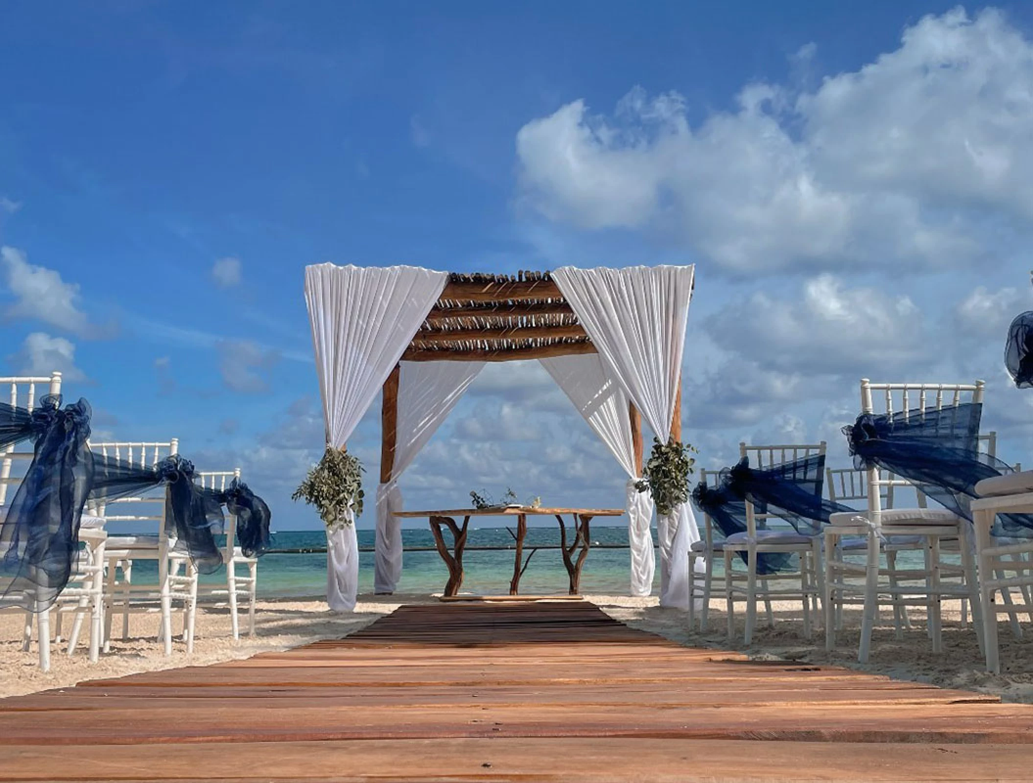 Ceremony decor in beach venue at Margaritaville Island Reserve Riviera Cancun.