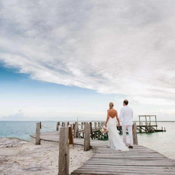 Couple walking throw The pier wedding venue at Nizuc Resort and Spa