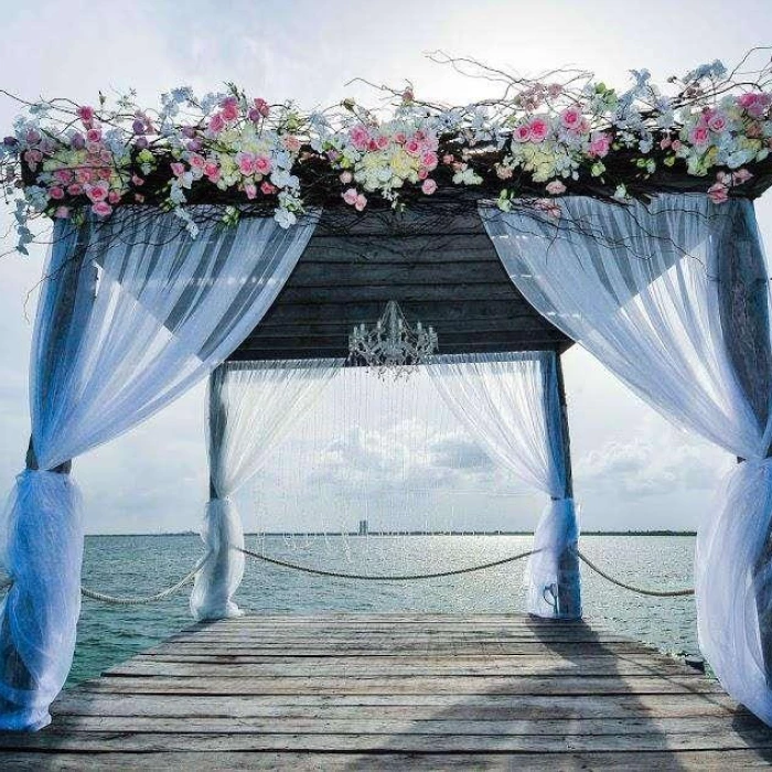 Ceremony decor on The pier wedding venue at Nizuc Resort and Spa