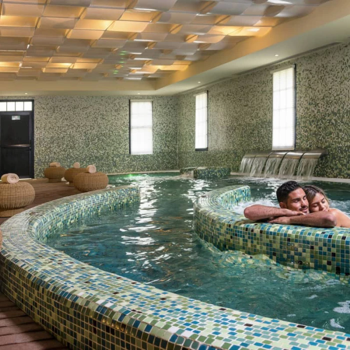 Couple relaxing on the jacuzzis at Ocean Coral & Turquesa resort spa